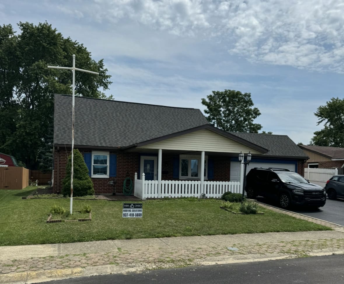 Single-story home with a covered front porch and a newly completed roof